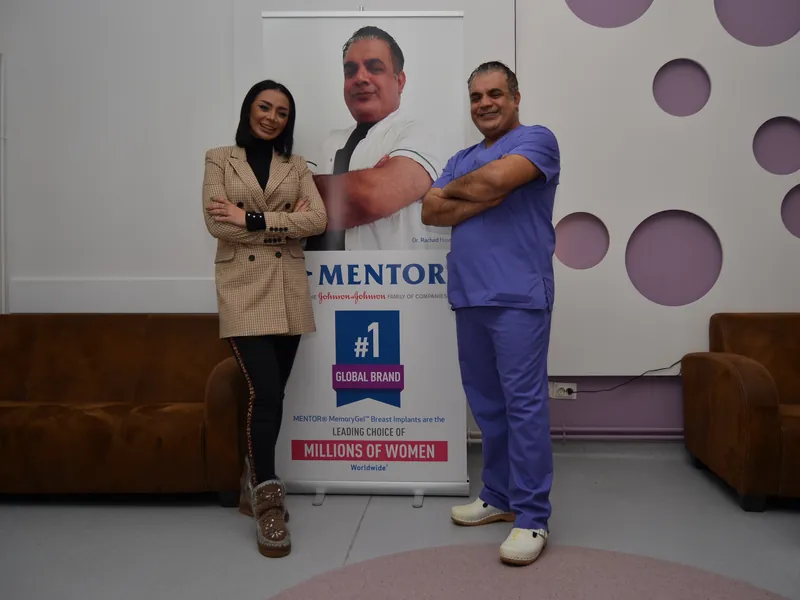 Dr. Rachad și o pacientă în clinica Art Estetica, lângă bannerul Mentor